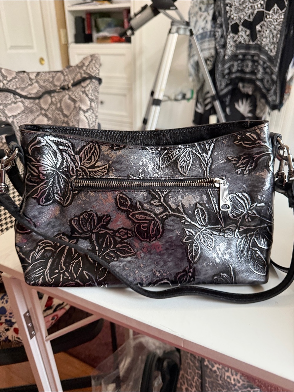 Rare tooled Patricia Nash crossbody 12” x 5”. Silver and black embossed.  NWOT.
